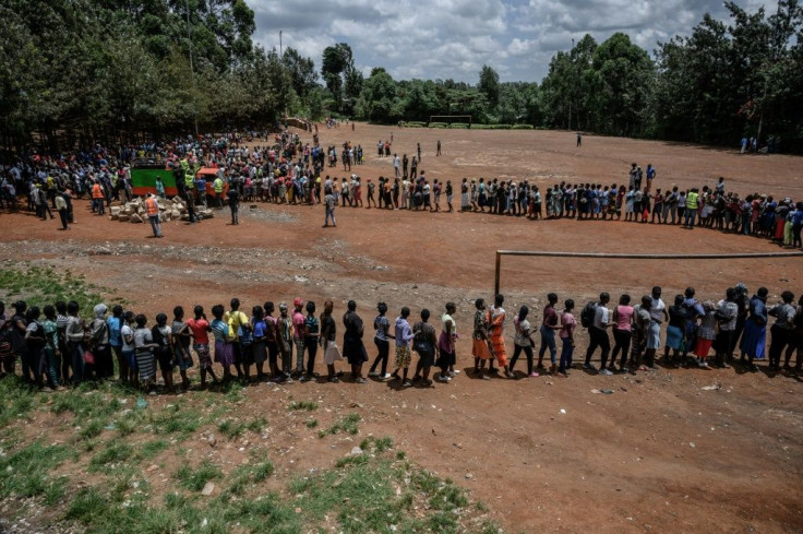 People queue for food handouts in Nairobi's Kibera slum