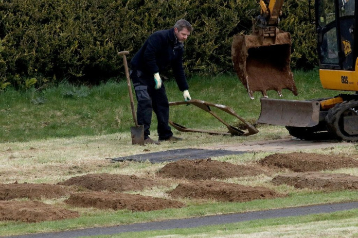 Workmen pre-dig graves at Sixmile Cemetery in Antrim, near Belfast, in Northern Ireland on April 2, 2020