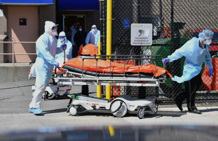 Medical staff move bodies from the Wyckoff Heights Medical Center to a refrigerated truck in Brooklyn, New York