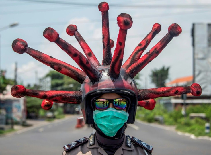 Indonesian police officers spread the message with special helmets while disinfecting vehicles