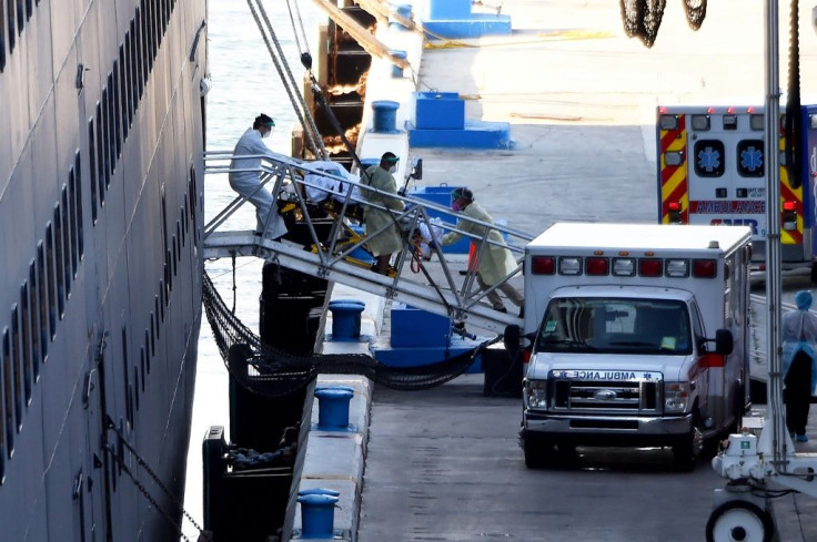 Medics transfer a patient on a stretcher from Holland America's cruise ship Zaandam after it docked at Port Everglades in Fort Lauderdale, Florida