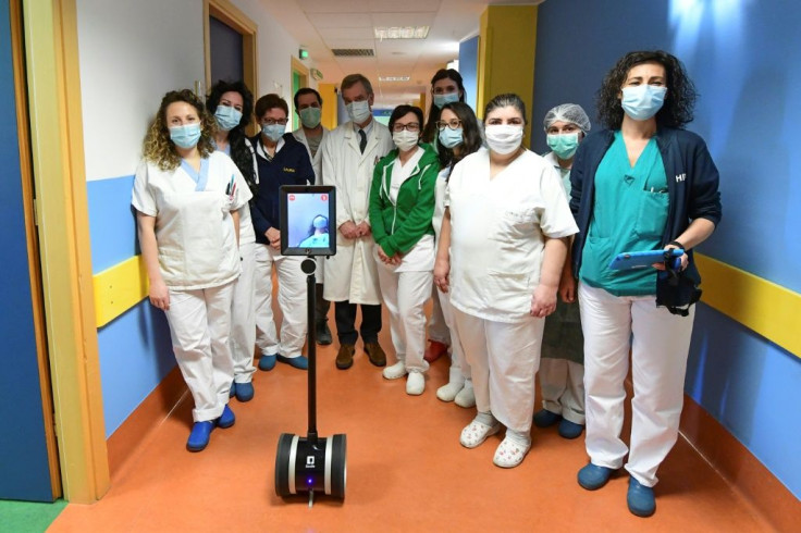 Medical staff in Varese, northern Italy, with Ivo the robot who helps them treat seriously ill coronavirus patients and reduce the risk of them getting infected