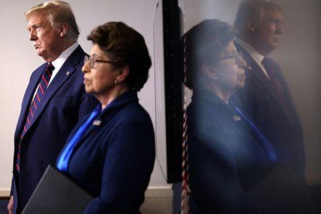 US President Donald Trump stands with the head of the Small Business Administration, Jovita Carranza, during a White House briefing on April 2