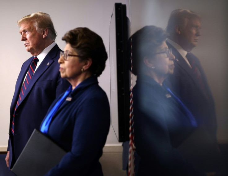 US President Donald Trump stands with the head of the Small Business Administration, Jovita Carranza, during a White House briefing on April 2