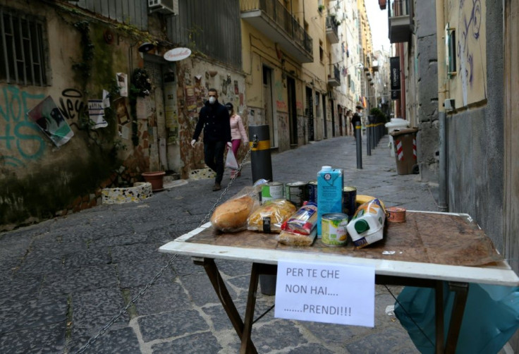 This solidarity table in a street in Naples is for people to leave food for those struggling to afford it