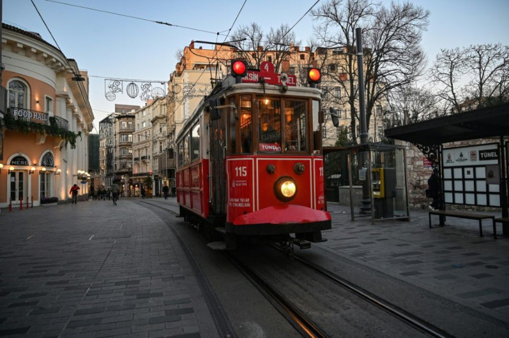 A tram drives along a nearly empty Istiklal Avenue in Istanbul