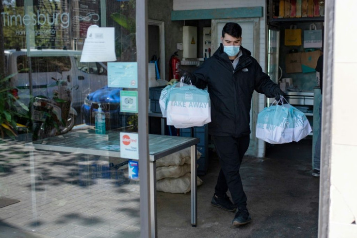 A delivery man leaves a restaurant with food for  health workers in Barcelona