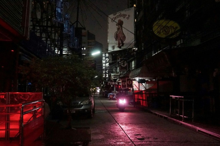 The occasional tourist loiters near clusters of sex workers, before a furtive negotiation and a quick march to a nearby hotel, one of the few still open on Bangkok's main tourist drag