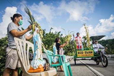Roman Catholic priest Pepe Quitorio delivers blessing from a motorised tricycle in Borongan in the central Philippines