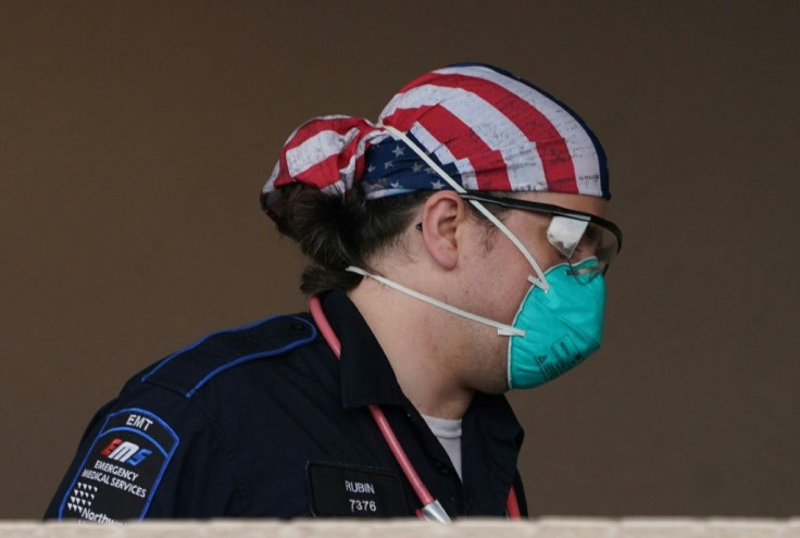 An EMT worker wheels a patient into Wyckoff Hospital in the Bushwick neighborhood of Brooklyn, New York