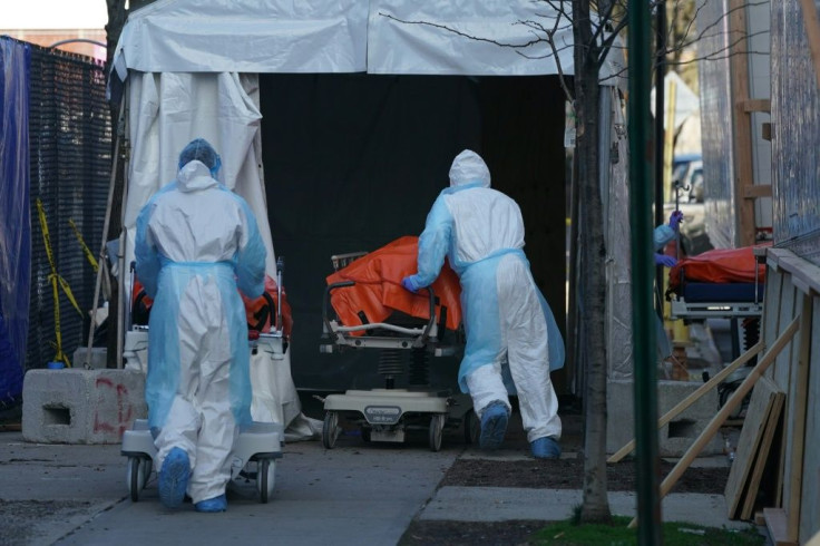 Bodies are moved to a refrigerator truck serving as a temporary morgue in Brooklyn.