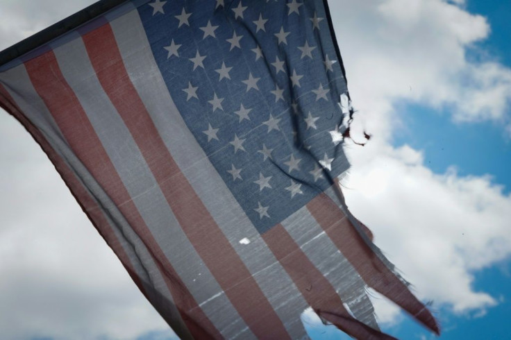 A tattered American flag hangs from a fence across the street from Wyckoff Hospital in Brooklyn