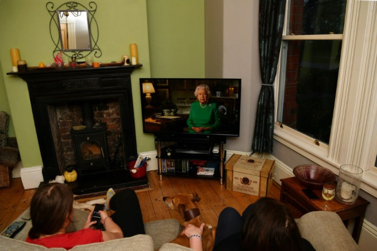 A family in Birkenhead, northwest England, watches the queen's broadcast as she said a united response would defeat the coronavirus