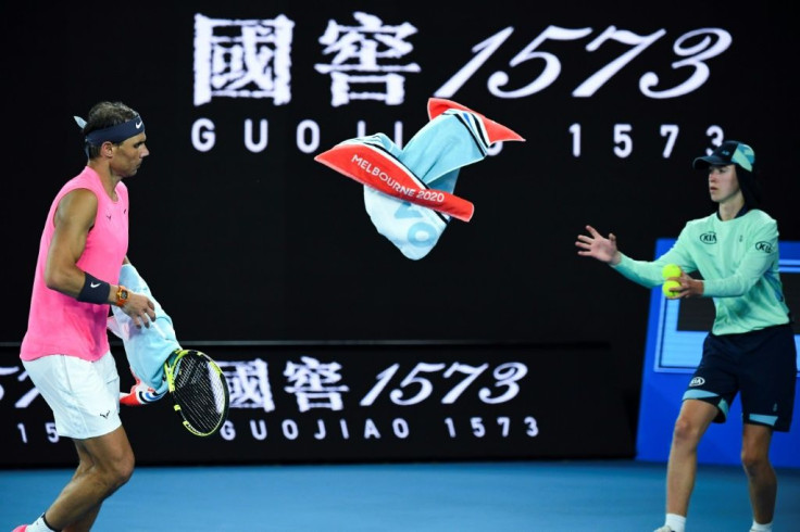 Catch: Rafael Nadal throws a towel to a ballboy at this year's Australian Open