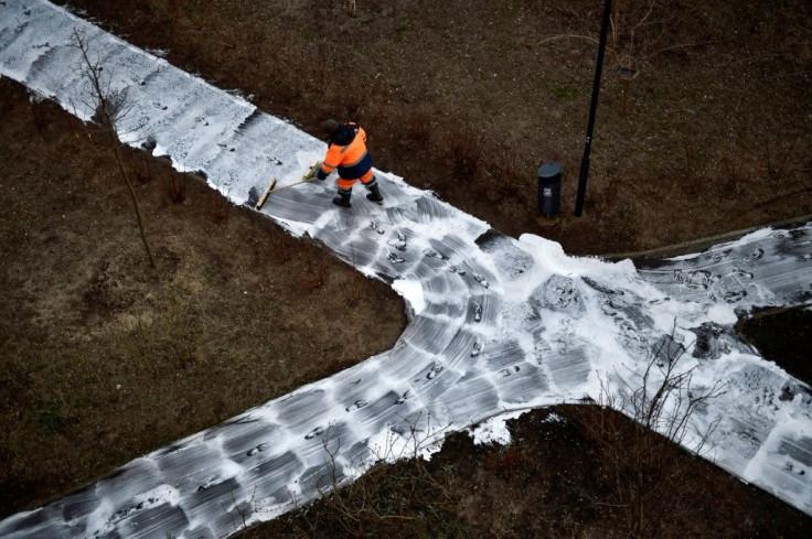 A municipal worker cleans and disinfects walkways in a yard in Moscow, during the strict lockdown in Russia