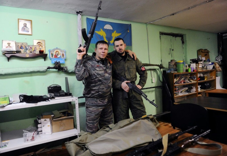 Members of the Russian Imperial Movement who are volunteers of the self-declared Donetsk People's Republic pose with weapon simulators at a training base in Saint Petersburg in 2015
