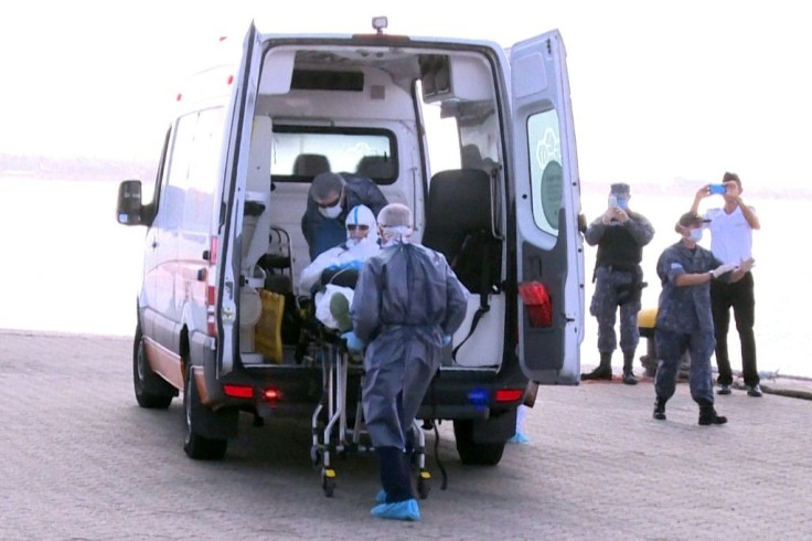 AFP TV grab shows a sick 75-year-old Australian passenger from the Greg Mortimer cruise ship being helped to board an ambulance in Montevideo, on April 3, 2020