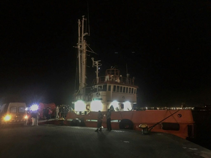 In this handout picture relased by Uruguay's Navy, medical workers help transfer an Australian cruise ship passenger to hospital in Montevideo late Sunday