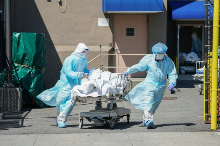 Bodies are moved to a refrigeration truck serving as a temporary morgue in New York, the main focus of the US outbreak, with more than 4,750 deaths