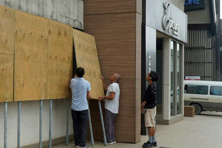 Locals board up their shop in Vanuatu's capital Port Vila ahead of Tropical Cyclone Harold