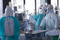 Healthcare workers in protective suits treat COVID-19 patients at Barcelona's Vall d'Hebron Hospital