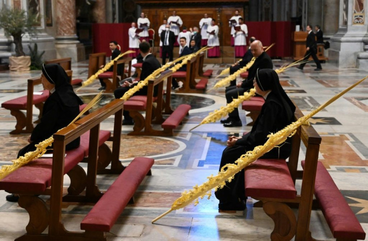 Palm fronds adorned largely empty pews as Pope Francis celebrated Palm Sunday mass in St. Peter's Basilica mass on April 5. Easter services are set to take place behind closed doors