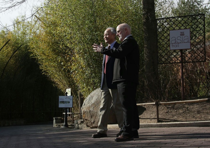 Chinese Ambassador Cui Tiankai (left) speaks to the director of the National Zoo, Dennis Kelly, as they wait for the departure of giant panda Bao Bao in February 2017