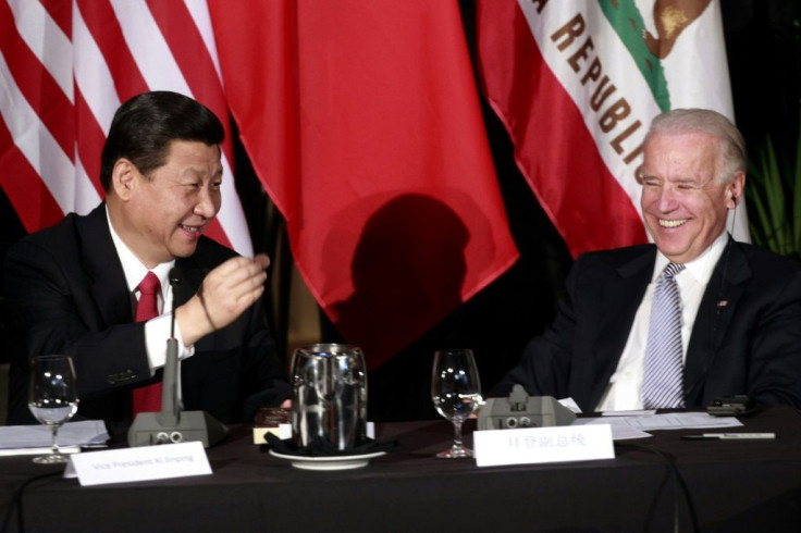 Xi Jinping shows Joe Biden a chocolate-covered macadamia nut presented to him at a 2012 meeting in Los Angeles when the two were both vice presidents