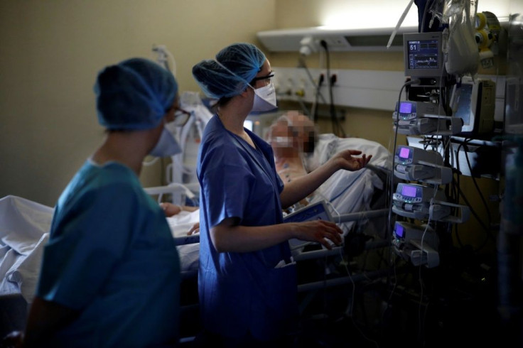 A nurse tends to an intubated and sedated patient infected with COVID-19 at the intensive care unit of the Peupliers private hospital in Paris