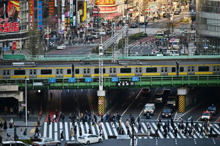 People cross a street in Tokyo on the same day Japan's Prime Minister Shinzo Abe declared a state of emergency in parts of the country, including Tokyo, over a spike in coronavirus infections