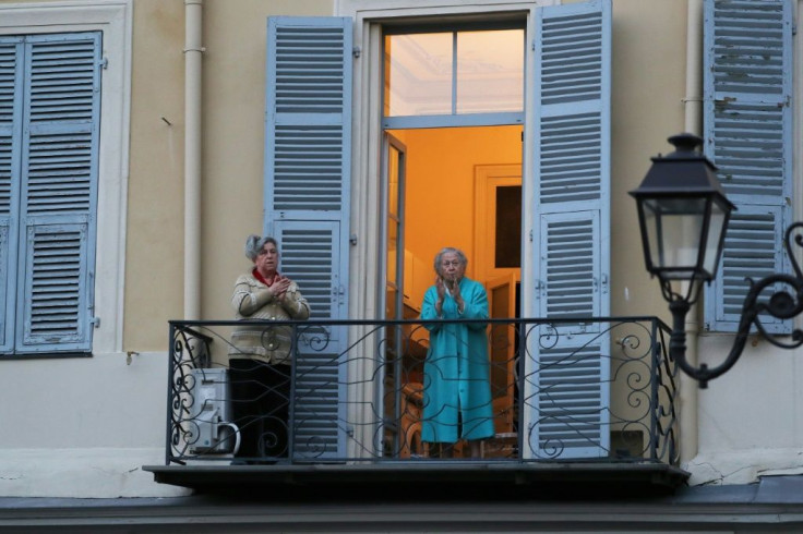 Women take part in the daily 8 o'clock applause in support of medical workers in the French Riviera city of Nice