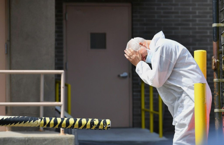 A medical personnel rubs his face outside the Wyckoff Heights Medical Center in Brooklyn, New York