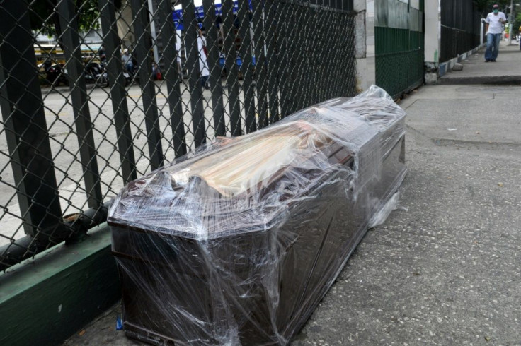 A coffin is seen on the pavement outside the Teodoro Maldonado Hospital in Guayaquil, Ecuador