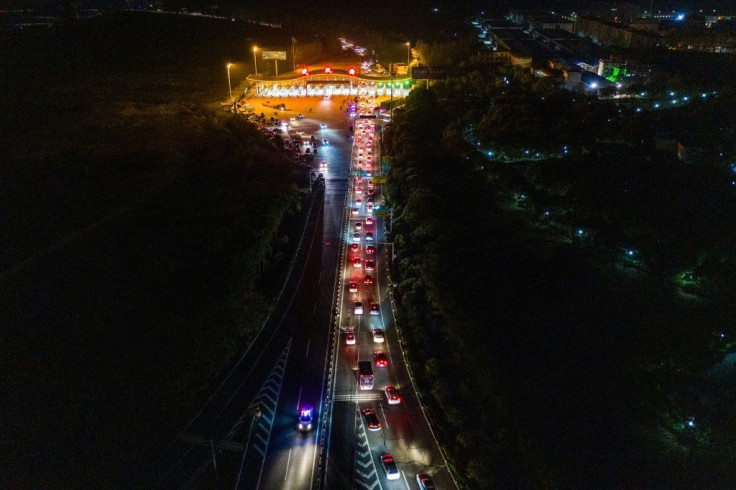 Cars queueing at a highway toll station in Wuhan in China's central Hubei province, as they prepare to leave the city after authorities lifted a more than two-month ban on outbound travel