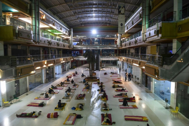 Migrant workers bed down at the shuttered JP Iscon mall in Ahmedabad, India