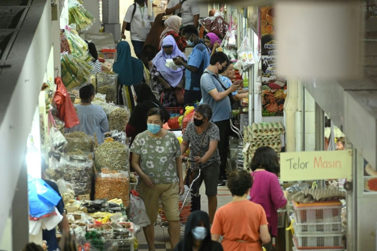 Shoppers in face masks mingle in the Geylang Serai market in Singapore