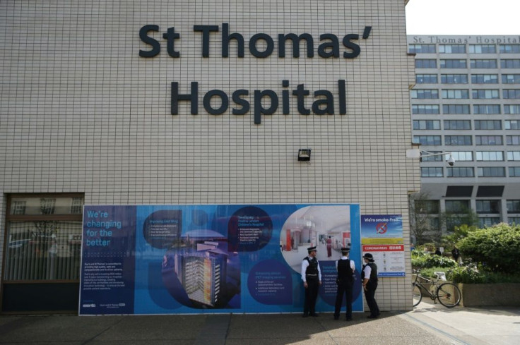 Police officers stand on duty outside St Thomas' Hospital