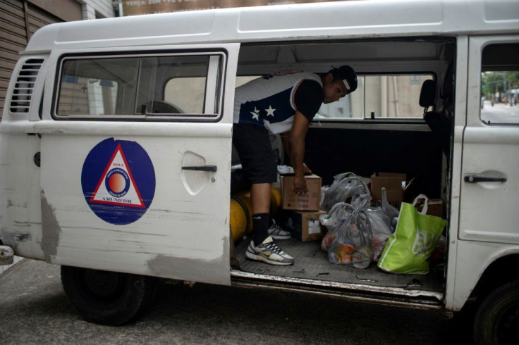 A volunteer loads a van with donations of basic food supplies for residents of the City of God favela -- one-quarter of Rio de Janeiro's residents live in such slums