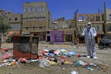 A Yemeni volunteer sprays disinfectant in a poor district of the capital Sanaa amid fears of a coronavirus outbreak