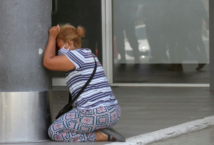 A woman cries after learning about the death of a relative at Los Ceibos Hospital in Guayaquil, Ecuador, on April 4, 2020 during the novel coronavirus pandemic