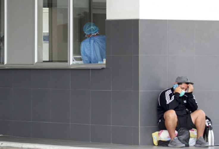 A man speaks on his phone at Los Ceibos on April 4, 2020. Some relatives of those infected with the virus have been waiting for days for news