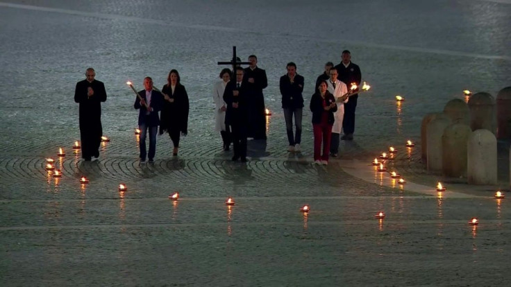 Doctors and nurses from the Vatican Healthcare Department carry the cross and mark the Stations of the Cross, during Good Friday's Way of the Cross (Via Crucis) at St. Peter's Square in The Vatican. The ceremony takes place during the lockdown aimed at cu