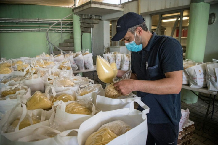 Volunteers prepare food donations for single mothers