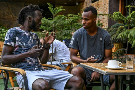 Real Kashmir players Armand Bazie (left) and Gnohere Krizo of Ivory Coast talk in their Srinagar hotel restaurant during the coronavirus lockdown