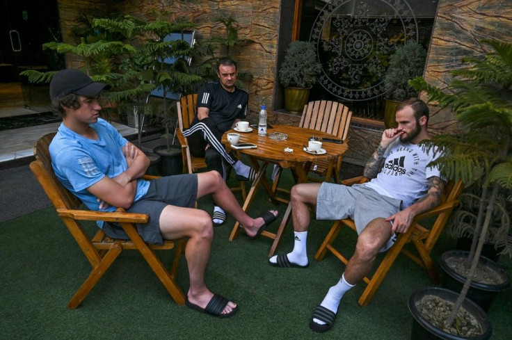 Kallum Higginbotham (right) of England, Scottish coach David Robertson (centre) and his son Mason while away the hours stranded at their Srinagar hotel