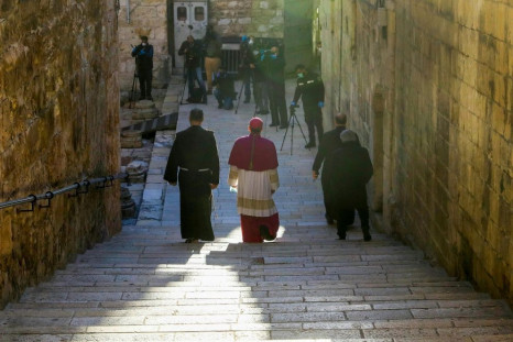 Archbishop Pierbattista Pizzaballa (C), Apostolic Administrator of the Latin Patriarchate of Jerusalem, makes his way through a largely empty Holy City to the Church of the Holy Sepulchre for the Easter Sunday service