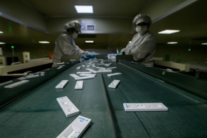 Sample devices used in diagnosing the COVID-19 novel coronavirus are checked on a production line in South Korea
