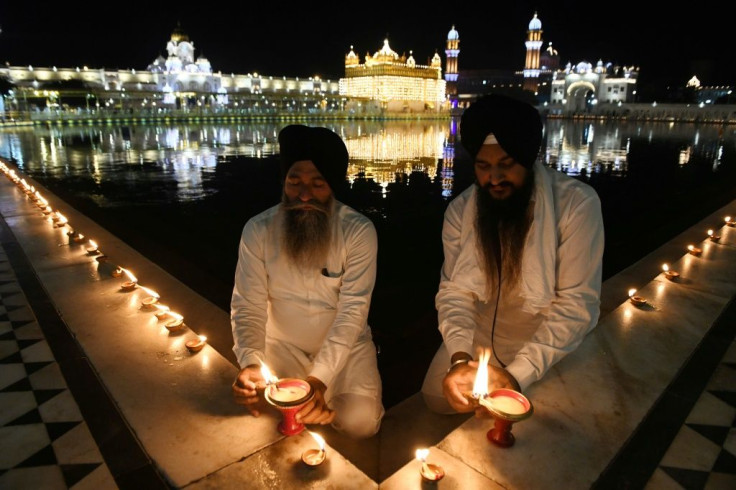 Devotees light lamps on the 399th birth anniversary of the ninth Guru, Teg Bahadur, at the  Golden Temple in Amritsar