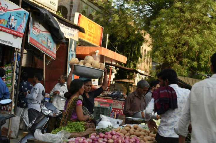 Shoppers buy supplies at a market in Ahmedabad