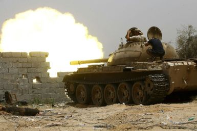 A file photo from June 2019 shows fighters loyal to the UN-recognised Government of National Accord (GNA) open tank fire south of the Libyan capital Tripoli during clashes with forces loyal to strongman Khalifa Haftar